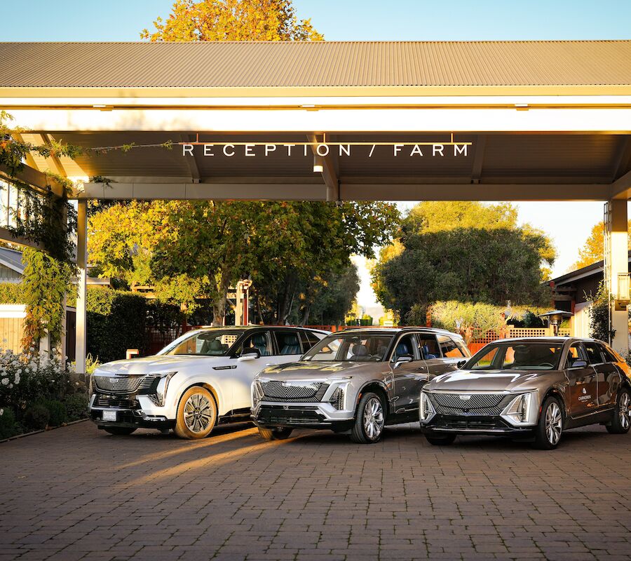 The image shows three cars parked under a structure labeled 